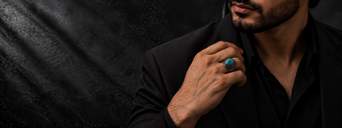 Man wearing a turquoise-coloured gemstone ring